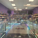 A bustling smoke shop environment displaying an assortment of items, from bongs to cigars and tobacco, arranged for easy browsing.