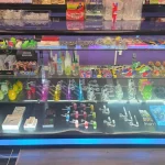 A bustling smoke shop environment displaying an assortment of items, from bongs to cigars and tobacco, arranged for easy browsing.