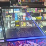 A bustling smoke shop environment displaying an assortment of items, from bongs to cigars and tobacco, arranged for easy browsing.