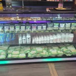 A bustling smoke shop environment displaying an assortment of items, from bongs to cigars and tobacco, arranged for easy browsing.
